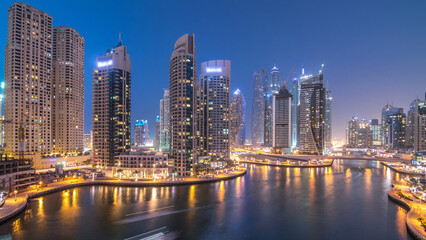 Beautiful aerial top view day to night transition timelapse of Dubai Marina canal