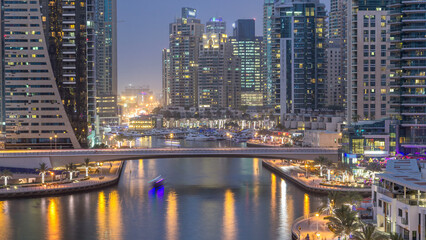 Naklejka premium Beautiful aerial top view day to night transition timelapse of Dubai Marina canal