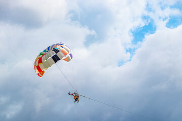 Patong Beach Phuket with parachute sport and parasailing activity Thailand.