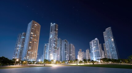 Fototapeta premium Nighttime Cityscape with Skyscrapers and Starry Sky Over Urban Landscape