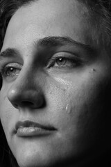 Obraz premium Closeup view of sad young woman crying. Black and white effect
