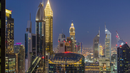 Skyline view of the buildings of Sheikh Zayed Road and DIFC day to night timelapse in Dubai, UAE.