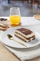 Tiramisu dessert with orange juice and coffee beans