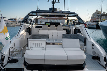 A luxurious yacht with spacious white seating and a stylish dining area, perfect for relaxing and entertaining on the water at Limassol Marina