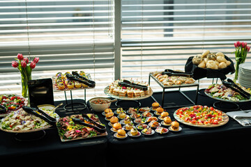 Gourmet buffet table with assorted appetizers and finger foods