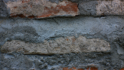 Brick wall with rough cement joints, weathered masonry texture background