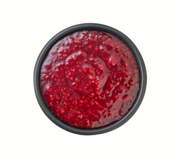 raspberry jam in a black bowl isolated on white background, top view.