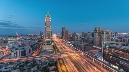 Skyline internet city with crossing Sheikh Zayed Road aerial day to night timelapse