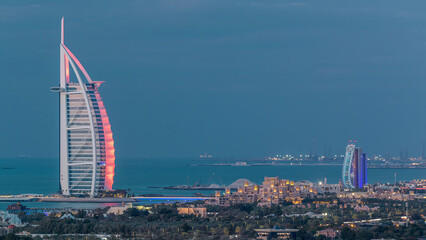 Aerial view of Burj Al Arab hotel from Internet city day to night timelapse.