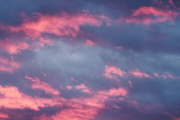 Moody grey blue sky with pink tinted clouds