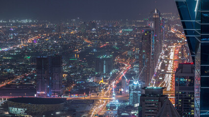 Skyscrapers on Sheikh Zayed Road and DIFC aerial day to night timelapse in Dubai, UAE.