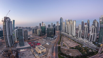 Obraz premium Panorama of Business bay Dubai night to day aerial timelapse.