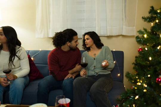 Couple having serious conversation during christmas reunion party