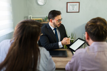 Lawyer advising couple completing visa application process