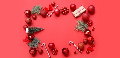 Frame made of Christmas decorations on red background, top view