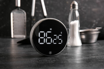 Modern kitchen timer on black table, closeup