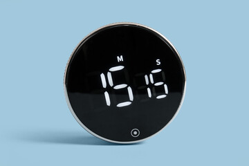 Modern kitchen timer on blue background