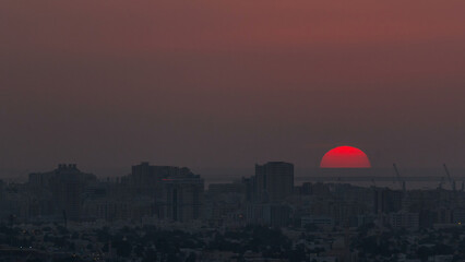 Sunset in Ajman aerial view from rooftop timelapse. United Arab Emirates.