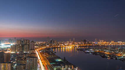 Obraz premium Cityscape of Ajman from rooftop day to night timelapse after sunset.