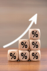 Interest rate financial and mortgage rates concept. Wooden blocks with Icon percentage symbol and arrow pointing up, The economy is improving