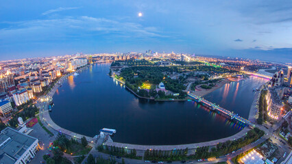 Elevated view over the city center with river and park and central business district day to night...