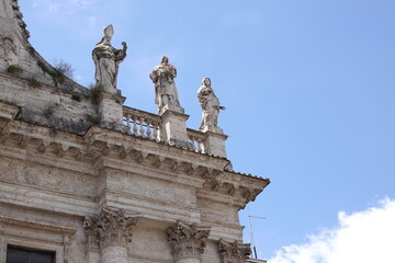 statues of roman priests on top of a church in rome italy