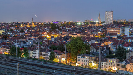 Aerial day to night timelapse panorama over Brussels skyline in Schaerbeek with Saint-Servais Church and Town Hall