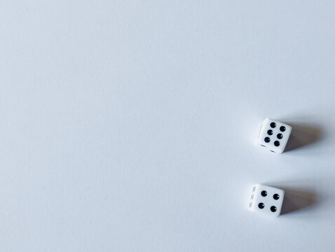 horizontal banner of two white dice showing six and four for business concepts