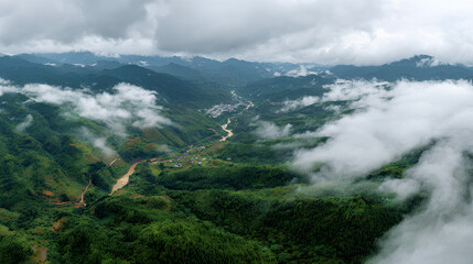 Clouds drift over a green landscape in Enshi City, Hubei Province, revealing hints of earth below.