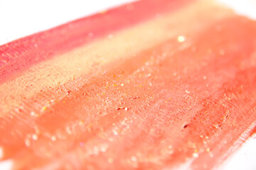 Smears of lipstick and powder eyeshadow creating layered composition. The fusion of art and beauty.