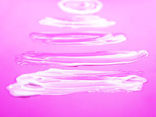 Soft white cream creating artistic organic shapes. Minimalistic beauty composition.