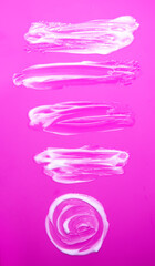 Soft white cream creating artistic organic shapes. Minimalistic beauty composition.