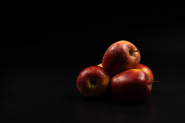 Red apples on a black background. Red apples.