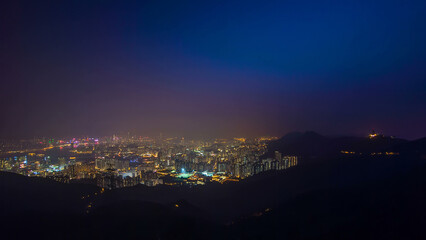 Cityscape of Hong Kong as viewed atop Kowloon Peak with day to night timelapse with Kowloon below