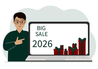 A man next to a large laptop, on his screen the text of big sales and a lot of gift boxes.
