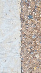 Textured Ground Surface with Gravel, Dirt, and Smooth Concrete Pathway for Urban Environments