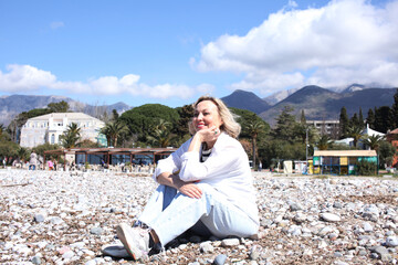 mature woman working outside in caffe on beach coast, lifestyle people concept