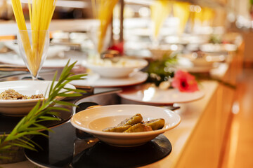 A vibrant buffet showcases a variety of dishes, including appetizers and salads, arranged elegantly in a dining venue