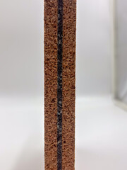 Close-up of cork and rubber composition board, showing fine grain and layered material.