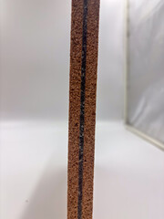 Detailed macro photo of cork layered panel with visible rubber line and textured natural surface.