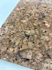 Close-up macro image of an expanded dark cork panel with visible large granules and organic texture.