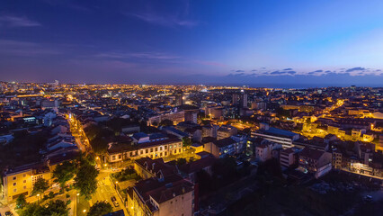 Rooftops of Porto's old town on a warm spring evening timelapse day to night, Porto, Portugal