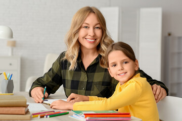 Fototapeta premium Little girl with book and tutor studying at home