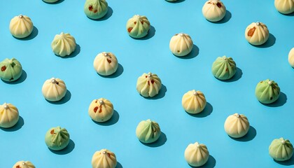 An overhead shot showcases a blue background filled with small, colorful buns arranged in a grid pattern, highlighting textures