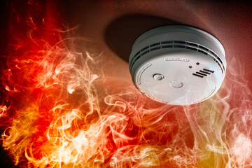 Smoke detector and fire alarm in action background