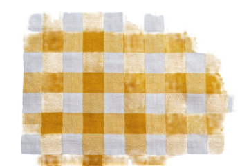 Close-up view of a partially cut, yellow and white checkered fabric. Isolated on black