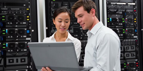 IT professionals in a server room analyze laptop data, developing blockchain strategies for efficient commodity trading and future market security