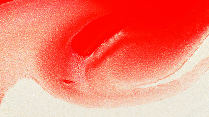 Close-up of red paint flowing on a shimmering golden paper surface. Abstract macro texture for artistic, creative, or graphic design use.
