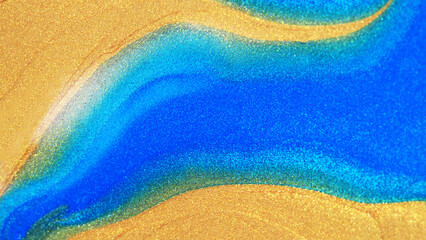 Macro abstract image of shimmering gold and vibrant blue texture blending smoothly like flowing sand or ocean waves. Perfect for luxury design, art, and creative backgrounds.