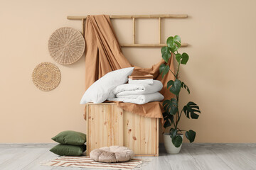 Interior of room with bed sheets, palm plant and ladder © Pixel-Shot